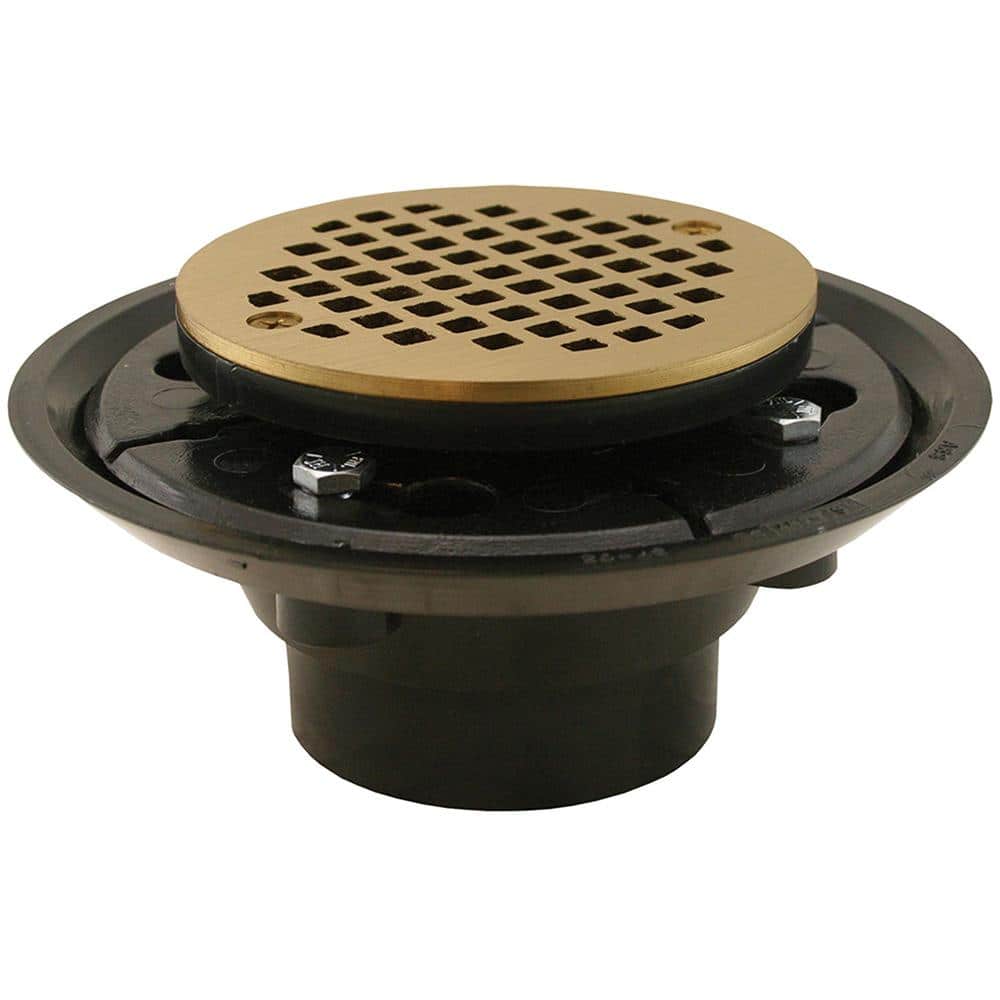 JONES STEPHENS 2 in. x 3 in. ABS Shower Drain/Floor Drain w/4 in. Polished Brass Cast Round Strainer-Fits Over 2 in. Sch. 40 DWV Pipe